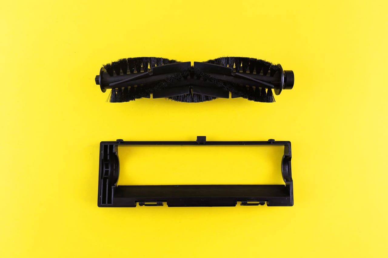Appliance repair Burlington VT: Vacuum cleaner parts on bright yellow background