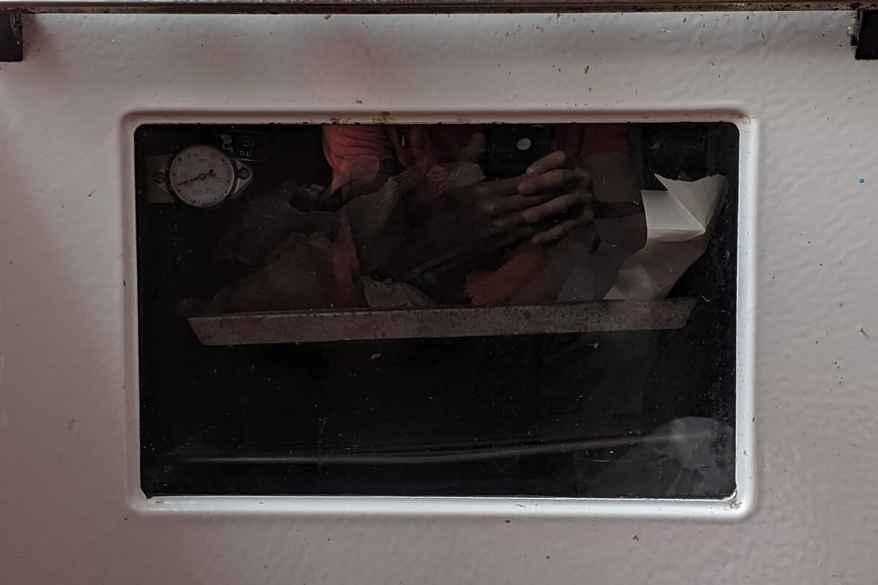Appliance repair Elizabeth NJ: Close up of oven and hands reflection in oven window