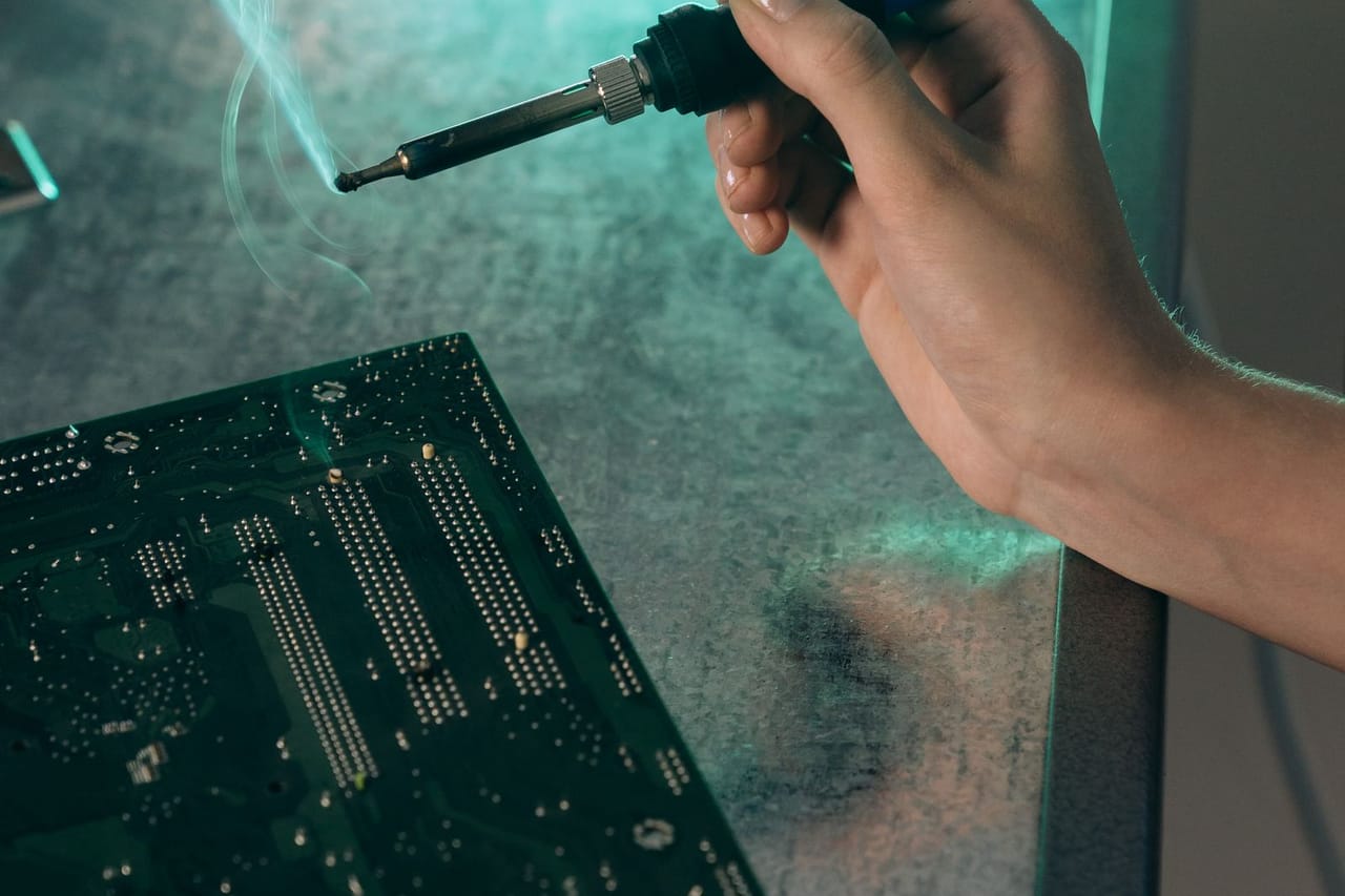 Appliance repair Farmington NM: A person holding a soldering iron