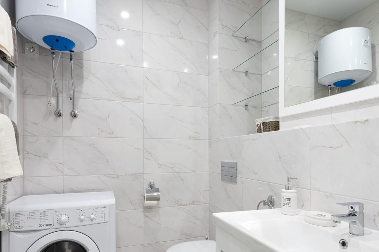Appliance repair Gainesville FL: White washing machine in the bathroom