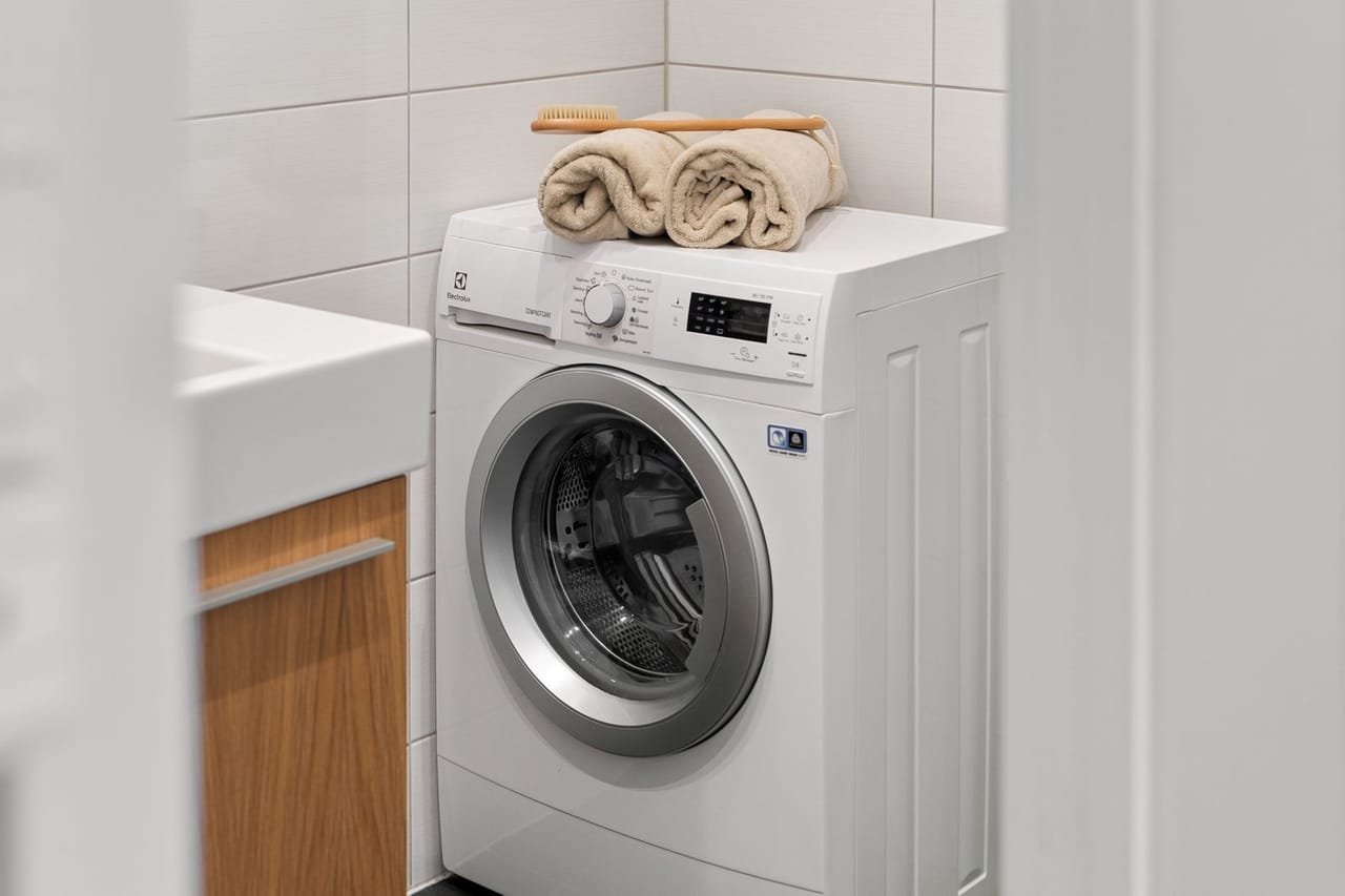 Appliance repair Lodi CA: White washing machine with beige towels