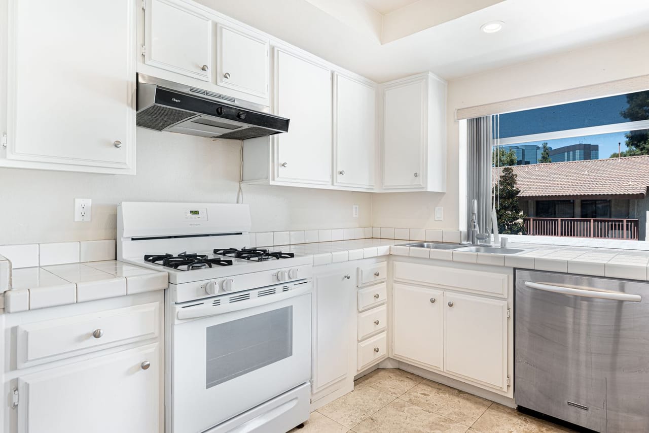 Appliance repair Marysville KS: A kitchen with white cabinets and stainless steel appliances