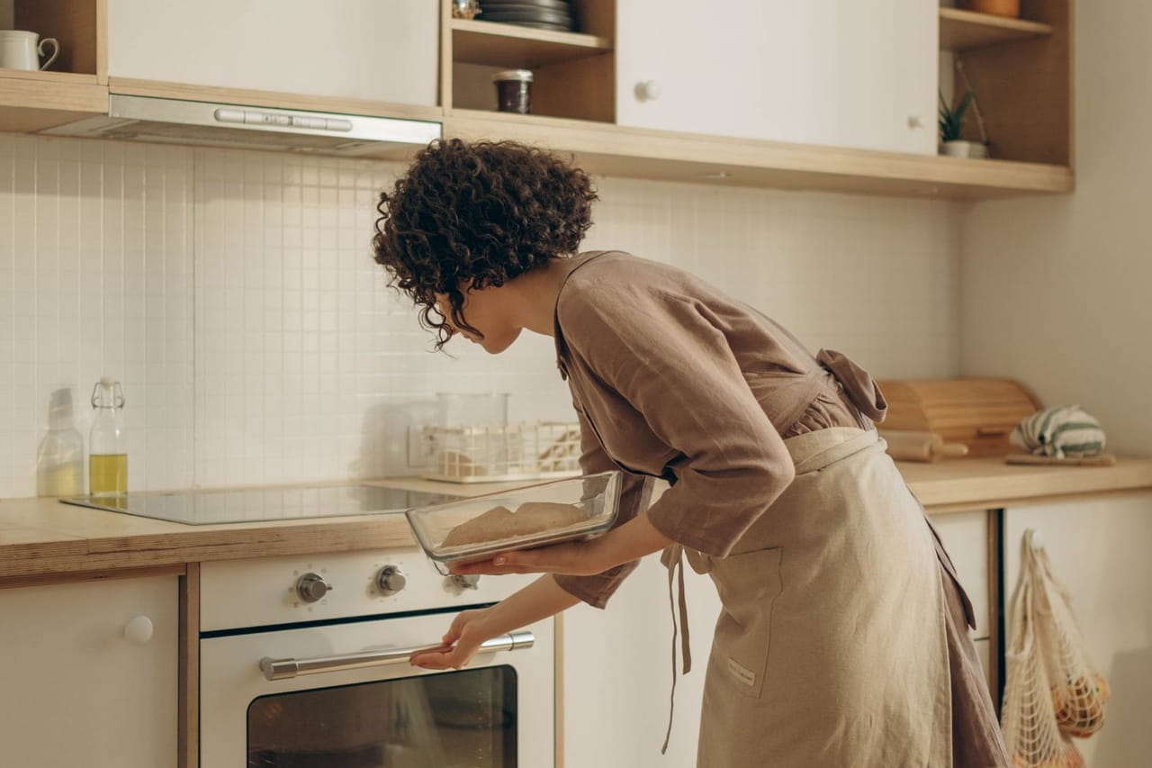 Appliance repair Medford OR: Woman cooking in an oven