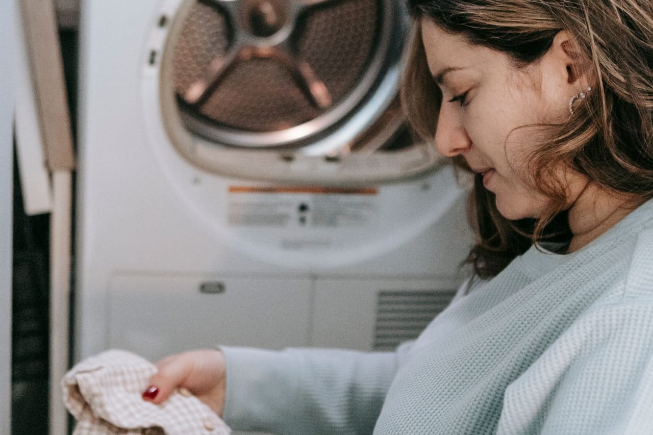Appliance repair Orlando FL: Woman with bag of dirty clothes