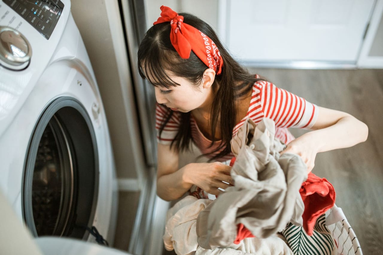 Appliance repair Overland Park KS: A woman with a bandana doing the laundry