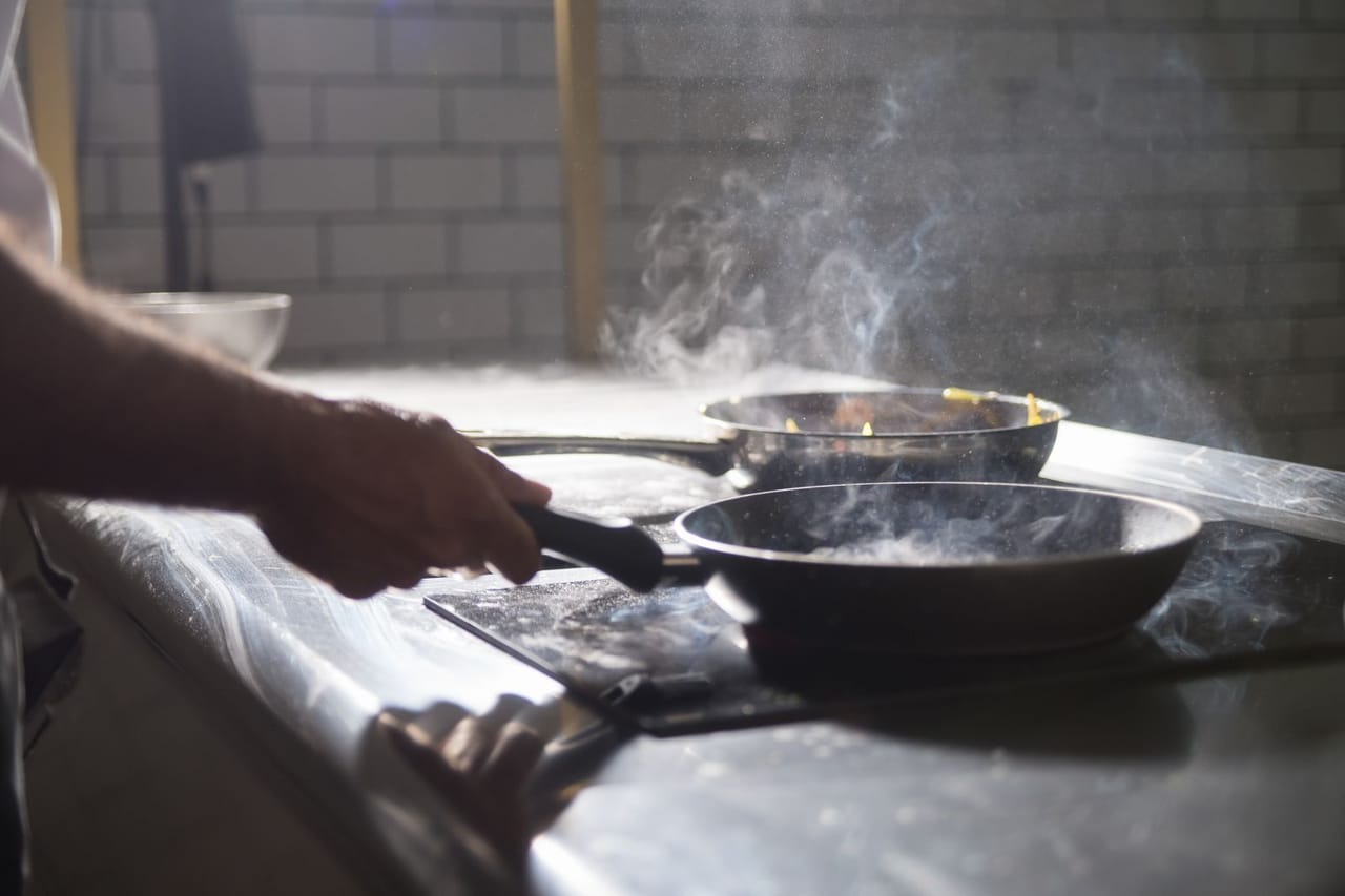 Appliance repair Pontiac MI: A person holding black frying pan