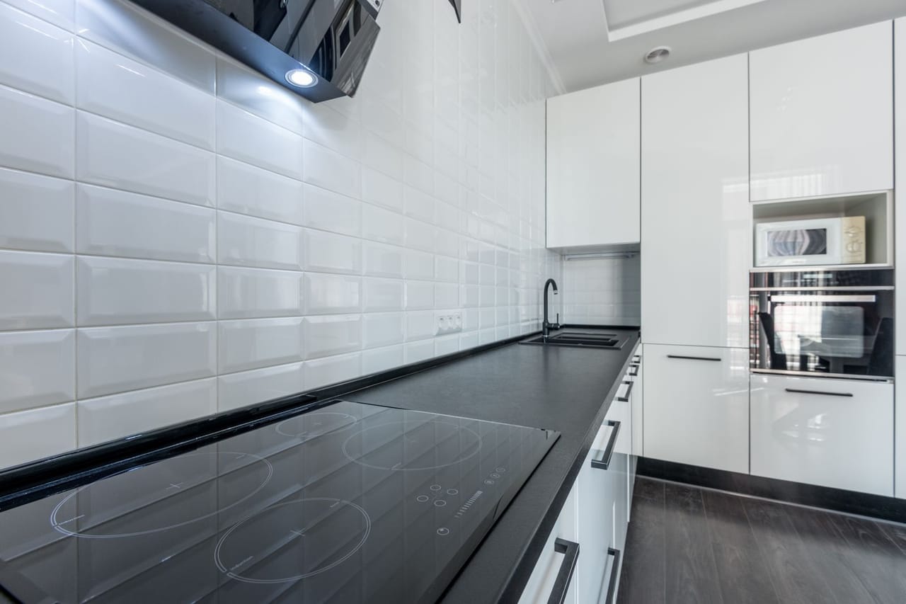 Appliance repair Salina KS: White kitchen with black counter and built in appliances