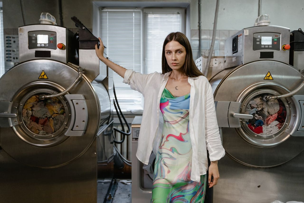 Appliance repair San Angelo TX: Woman standing between washing machine