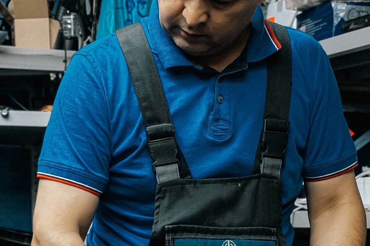 Appliance repair Santa Ana CA: Man in workshop fixing a power tool