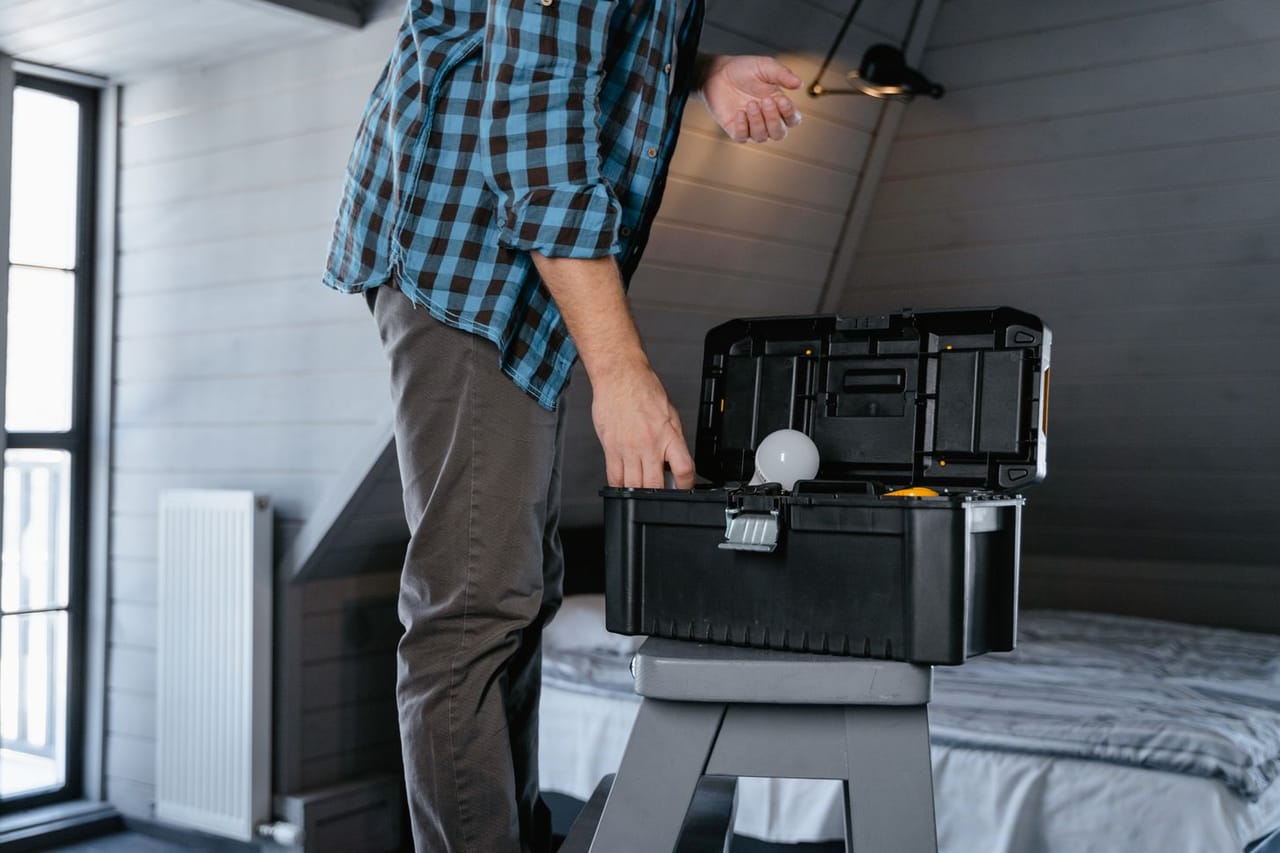Appliance repair Santa Barbara CA: A person in plaid long sleeves standing near the toolbox