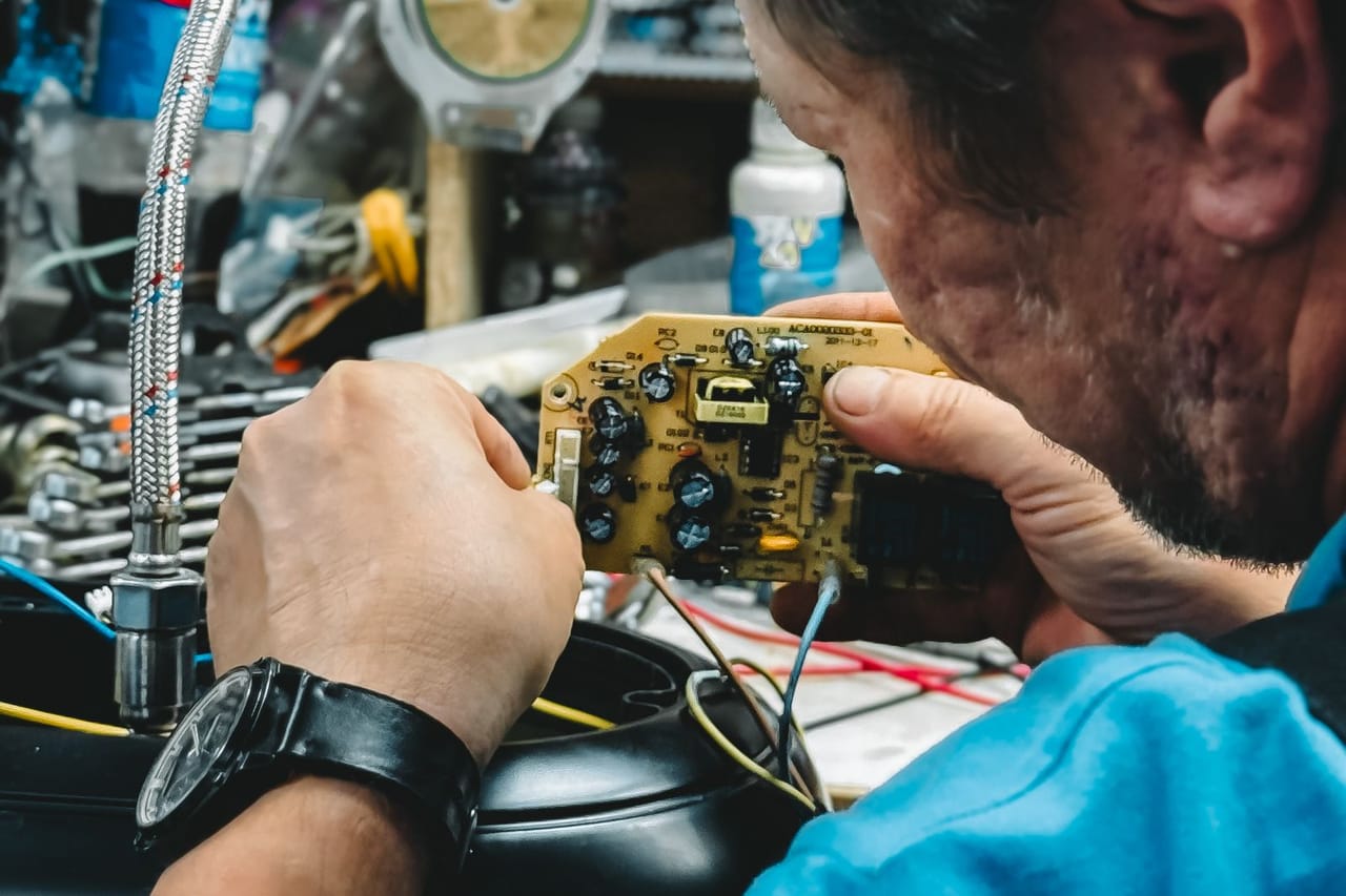 Appliance repair Santa Clarita CA: Man repairing electronics in workshop