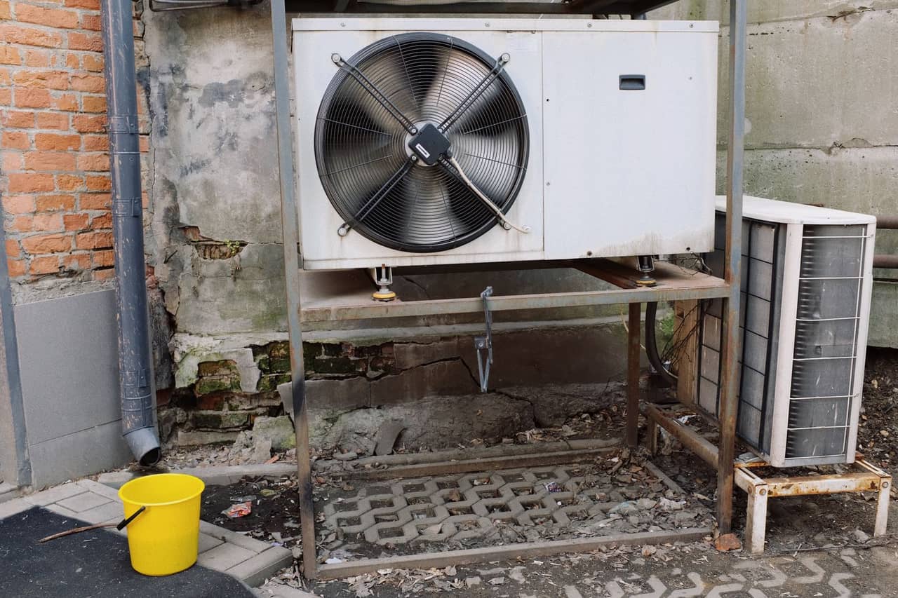 Appliance repair Schaumburg IL: Air conditioner unit near wall of modern building on street
