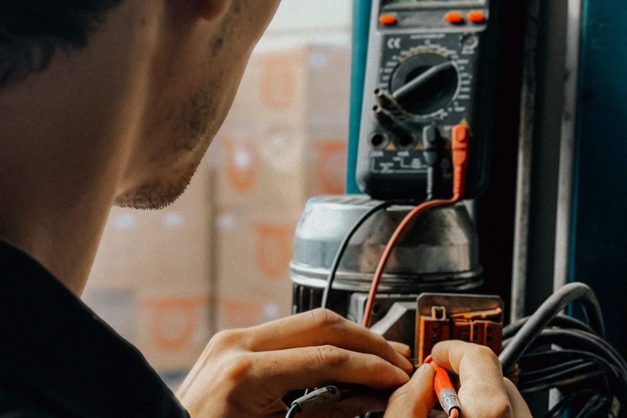Appliance repair Slidell LA: Electrician working with multimeter in workshop