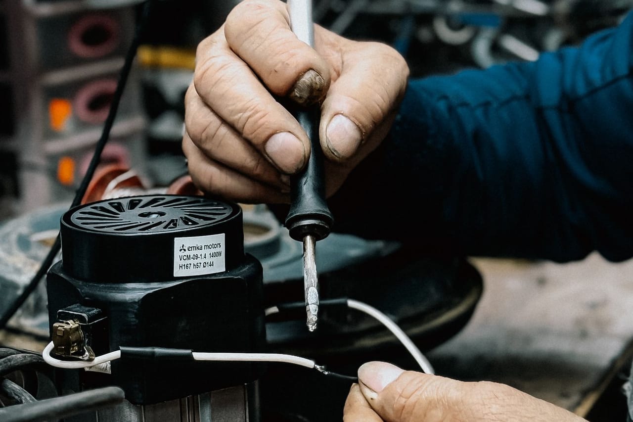 Appliance repair South Bend IN: Technician soldering electrical components in workshop