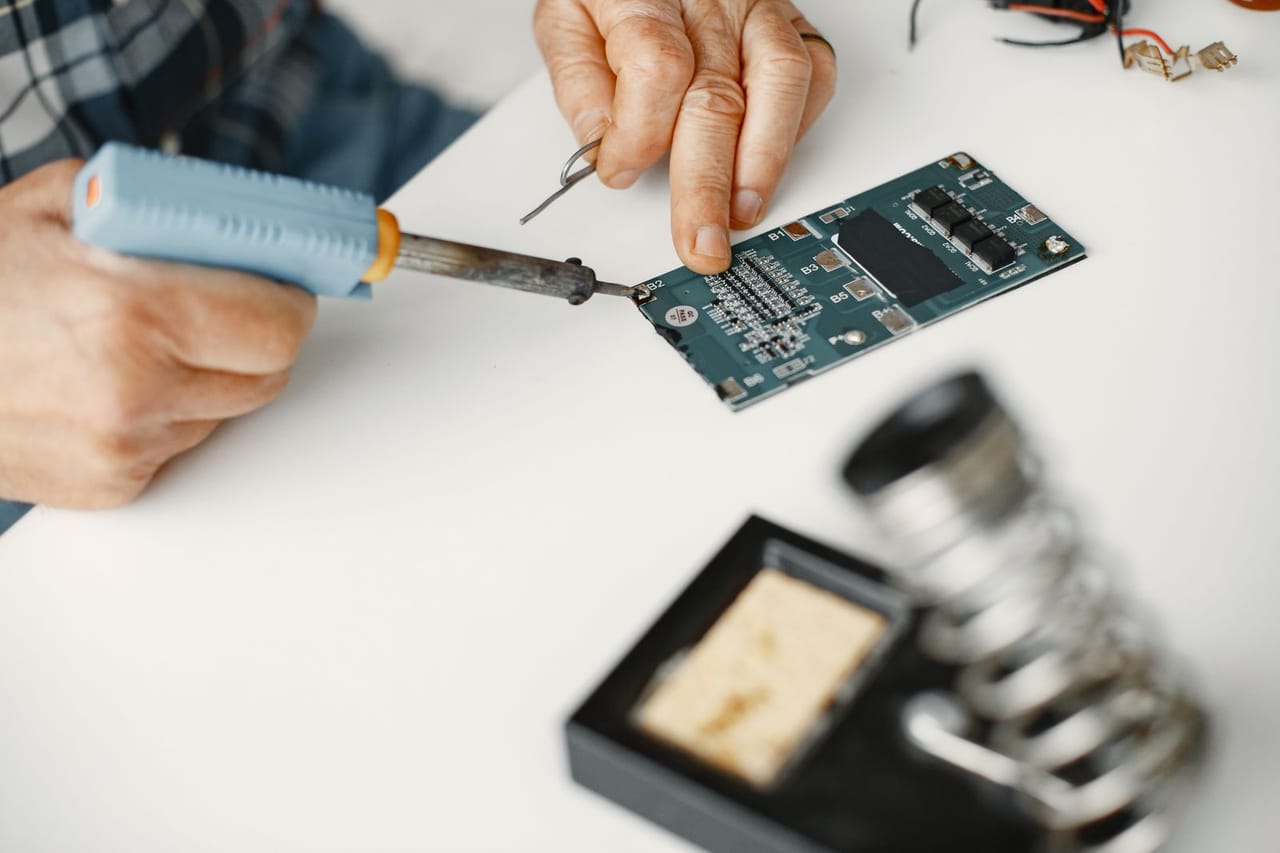Appliance repair Southaven MS: Close up of a man soldering
