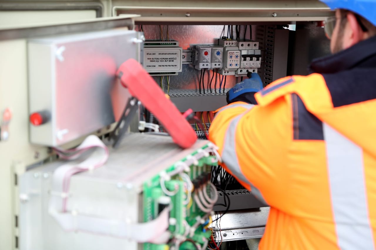 Appliance repair Spartanburg SC: A man maintaining an inverter