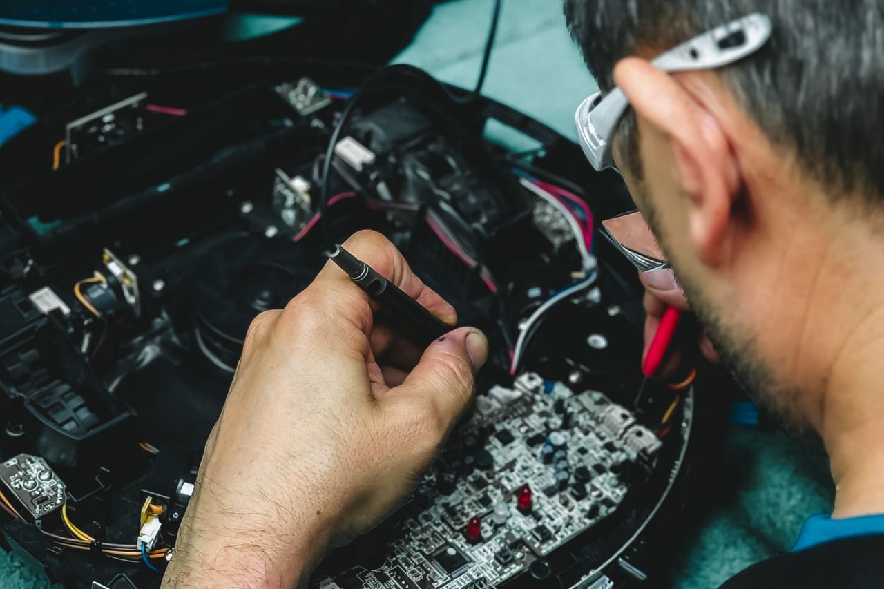 Appliance repair Springfield IL: Technician repairing electronics circuit board