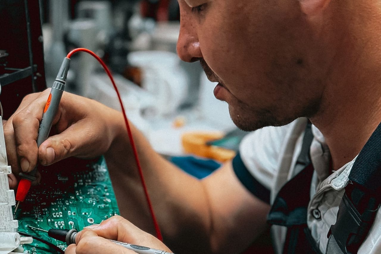 Appliance repair St Clair Shores MI: Focused technician repairing circuit board