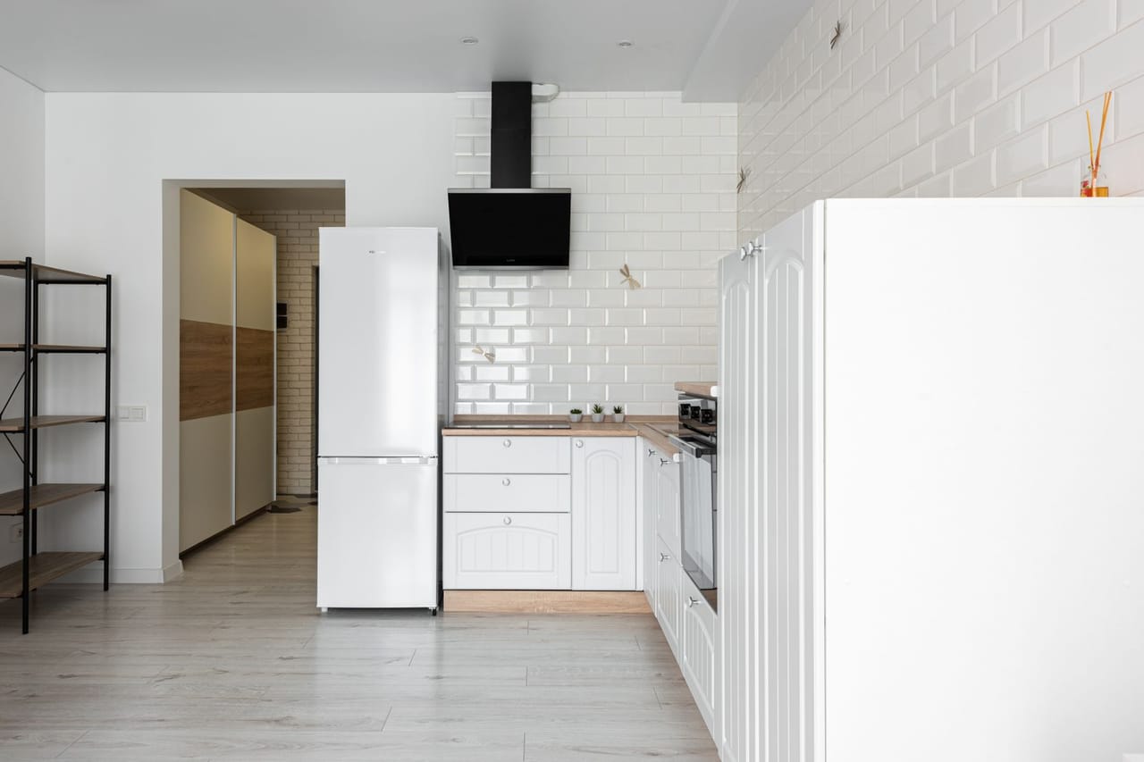 Appliance repair Tampa FL: Modern kitchen interior with fridge and cabinets at home
