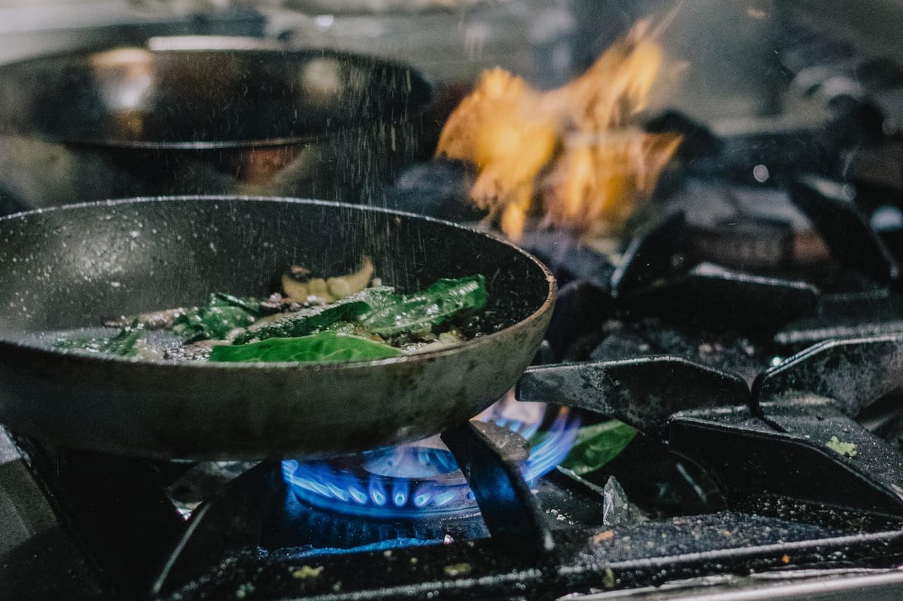 Appliance repair Yuma AZ: A person cooking using a stove