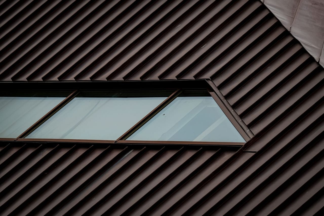 Can you replace a roof in winter: Windows in metal brown textured roof