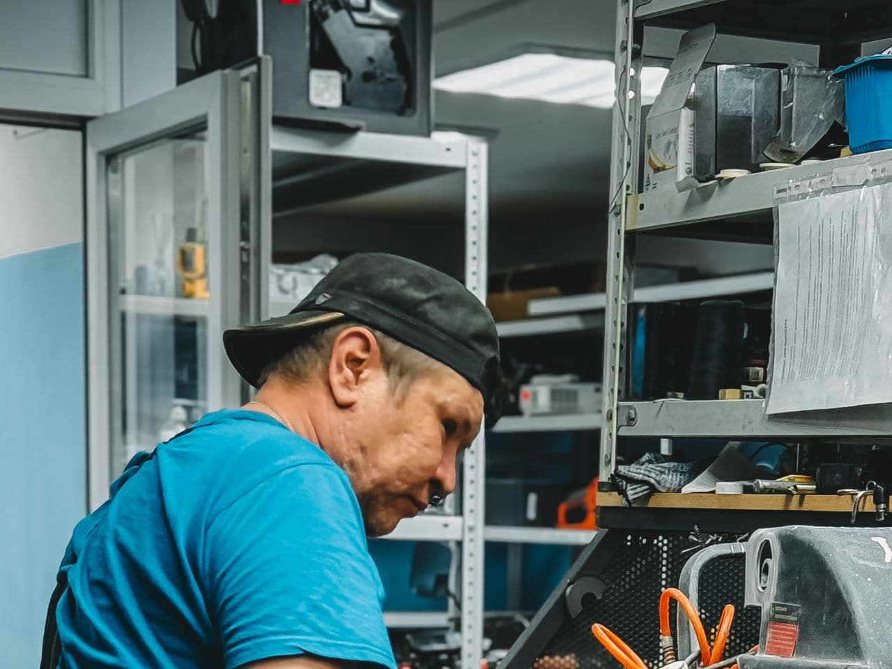 Dishwasher not dissolving pods: technician working inside an appliance with orange wiring