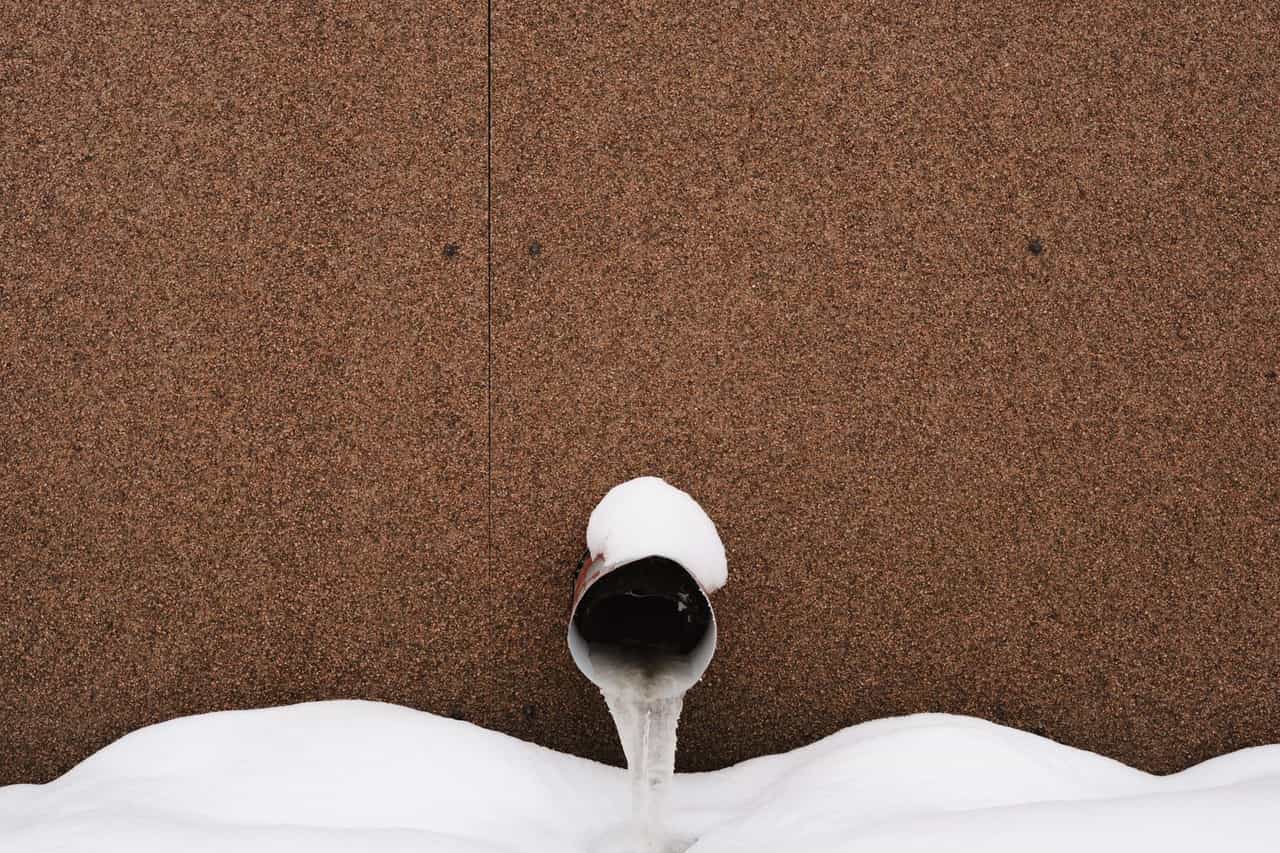 Does frozen pipe always burst: Frozen pipe in snow against building wall