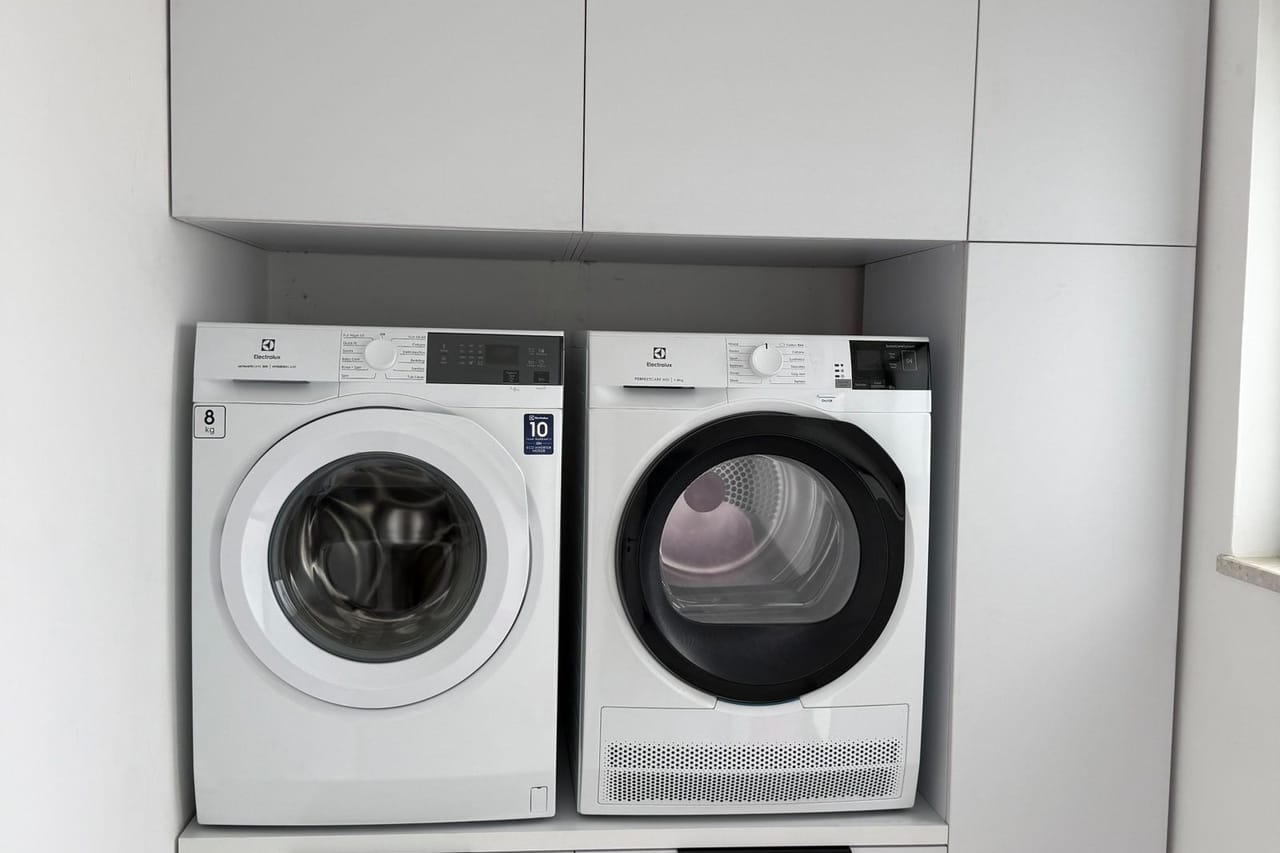 Dryer smells like burning: Modern laundry room with washer and dryer setup