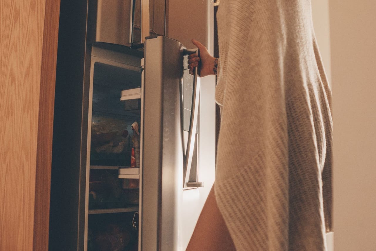 Dryer won't start: Woman opening the door of the refrigerator