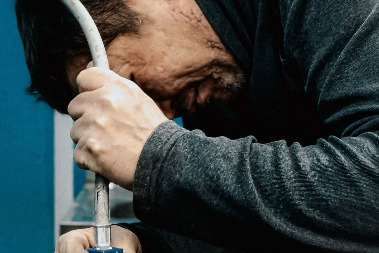 Garbage disposal not working: Focused technician working with water pump