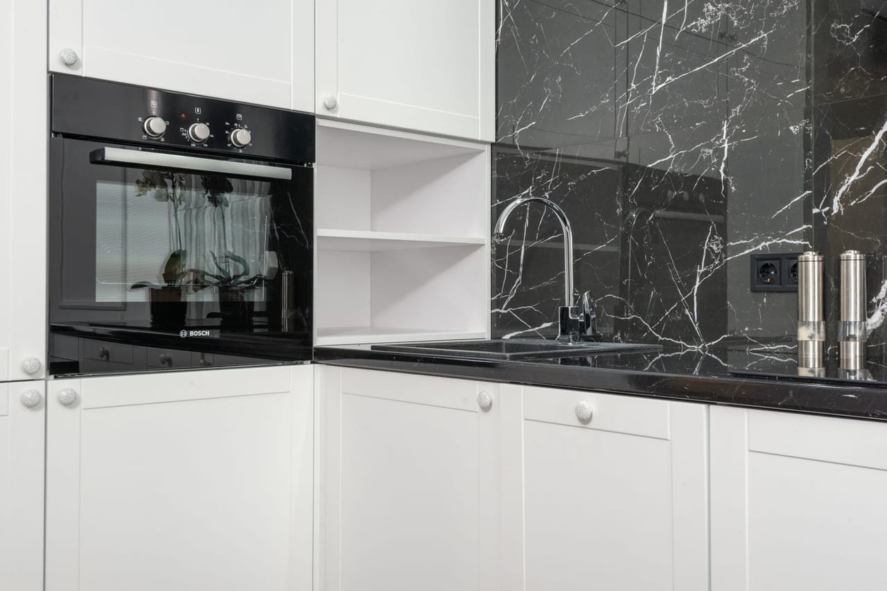Gas oven won't light: Light kitchen interior with white furniture and modern built in oven