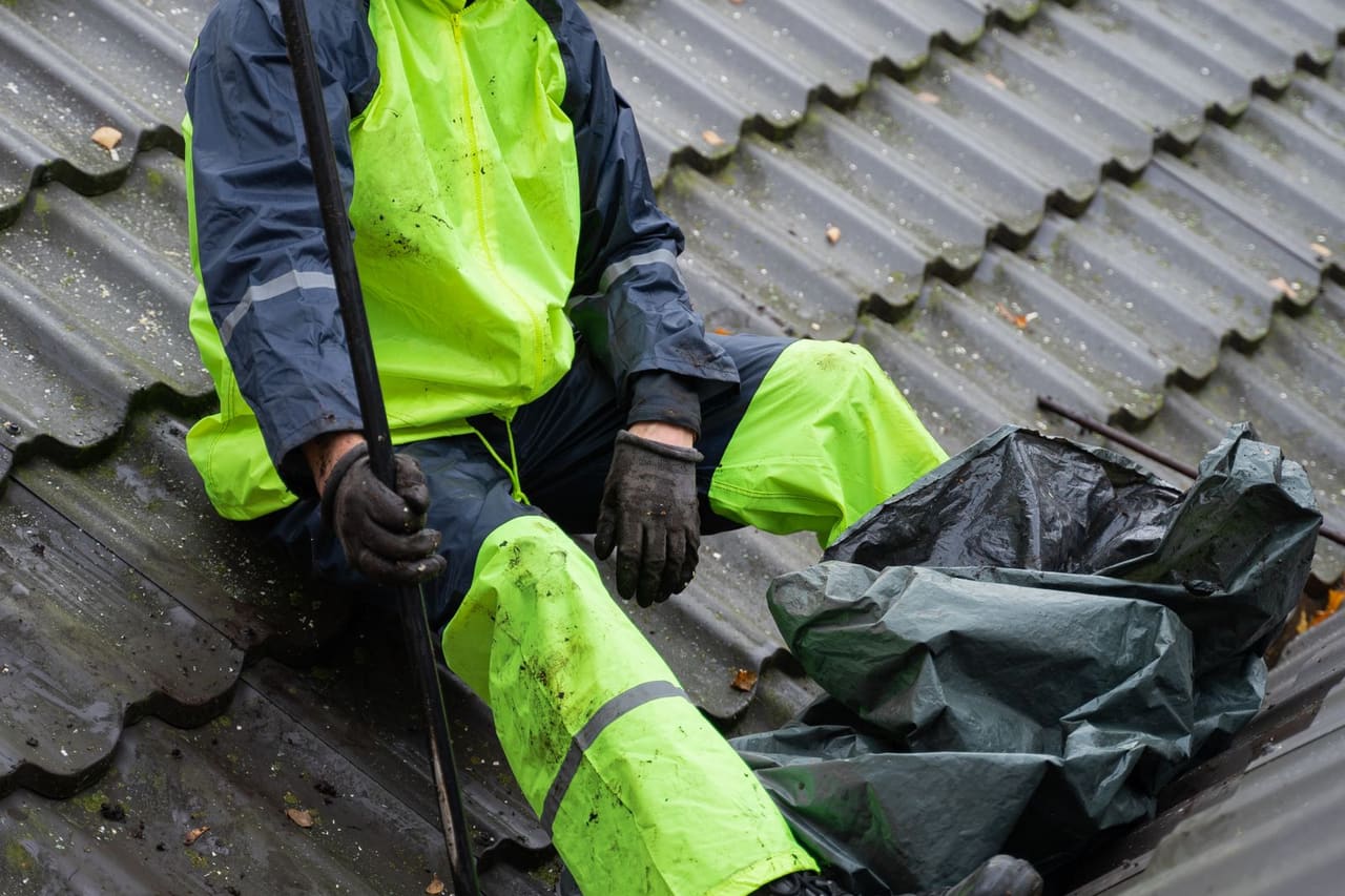 Granules in gutters: A man working n the roof