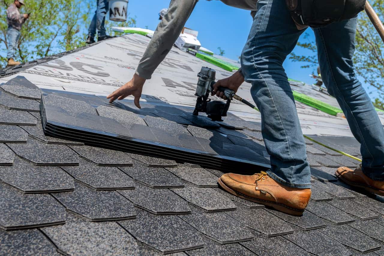 How many bundles of shingles in a square: Professional roofer installing shingles on new roof