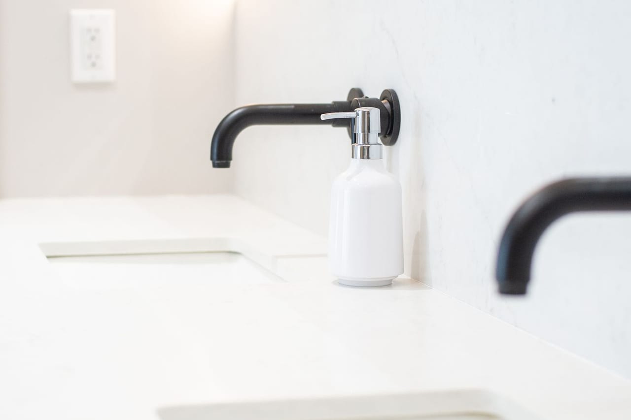How to clean a garbage disposal: Clean white bathroom sinks