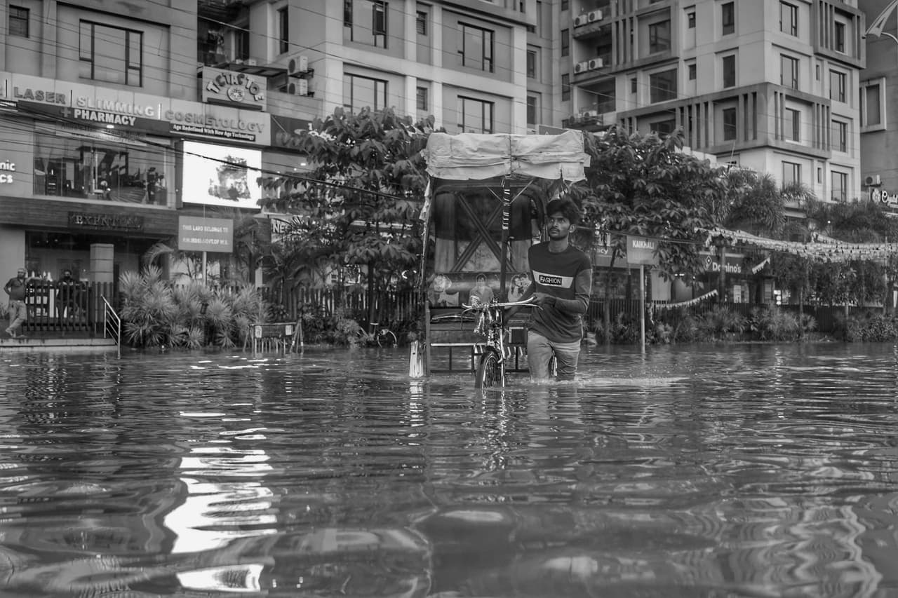 How to prevent a flooded basement: A man pushing a rickshaw on a flooded street