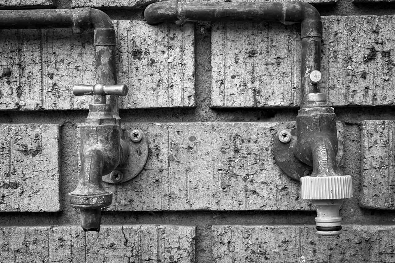 How to prevent frozen pipes: Rustic outdoor plumbing pipes and taps