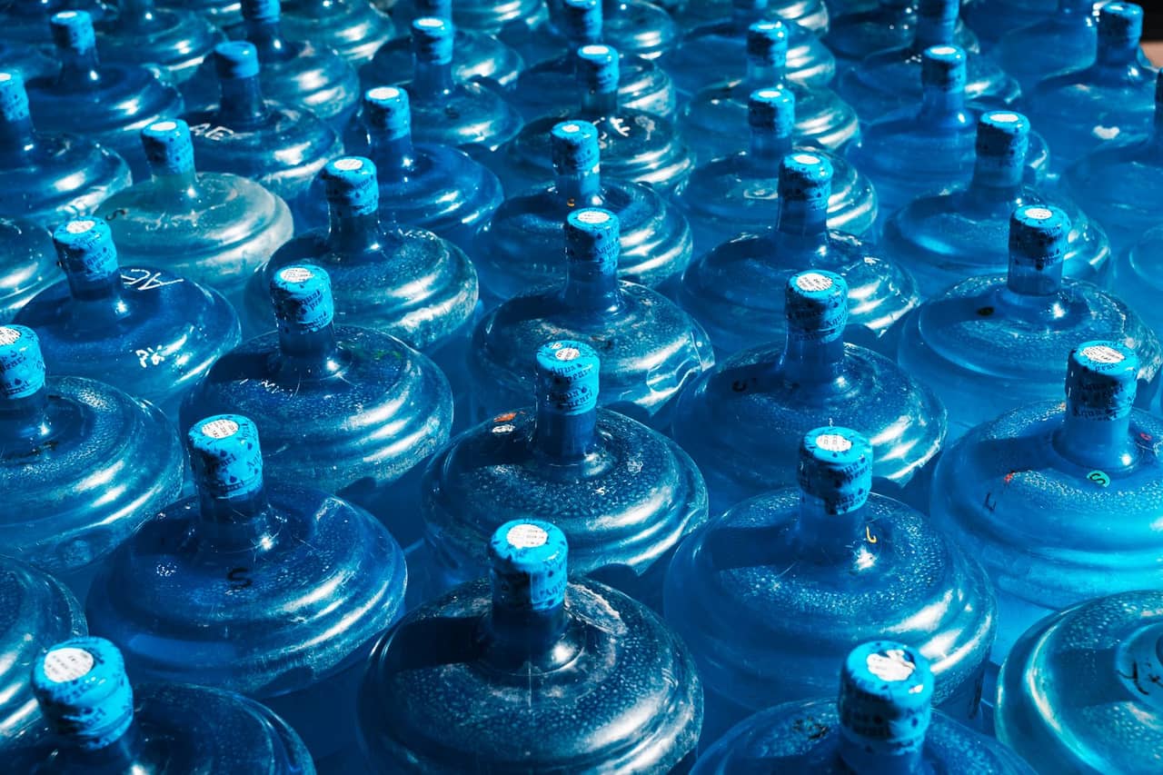How to relight a water heater pilot light: Array of blue water containers in bright light
