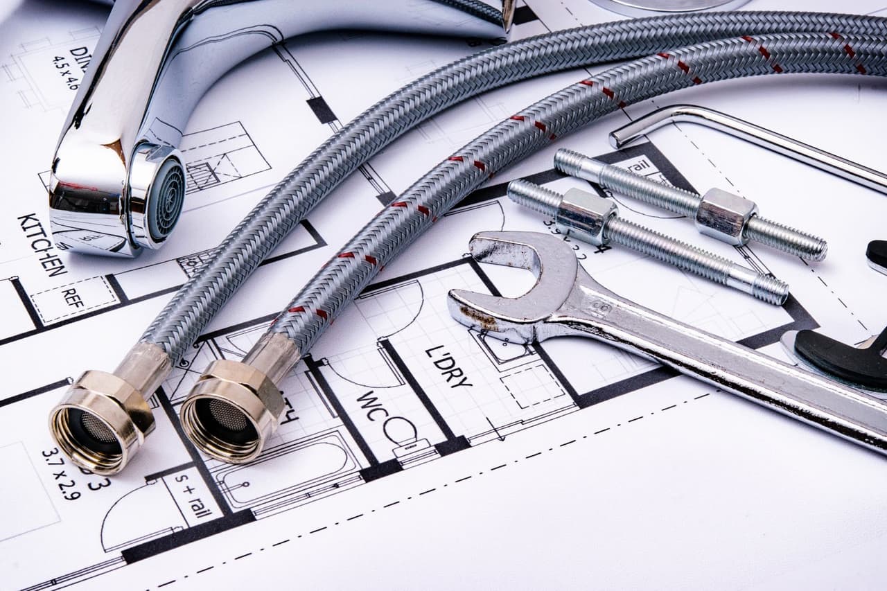 How to replace a garbage disposal: Wrench and pipes on sketch