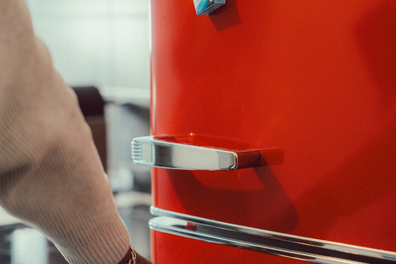 How to replace a refrigerator door gasket: Red retro refrigerator with hand opening door