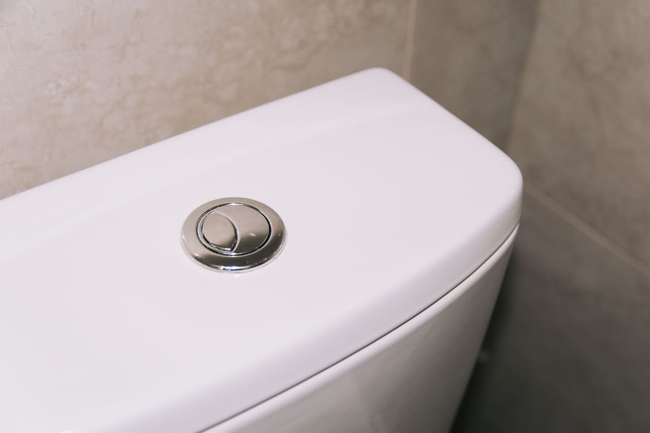 How to replace a toilet fill valve: A white ceramic toilet bowl with dual flash