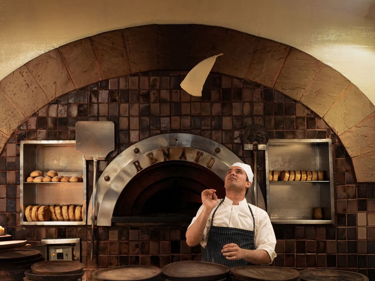 Oven igniter repair: stone oven with a fire lit at its mouth