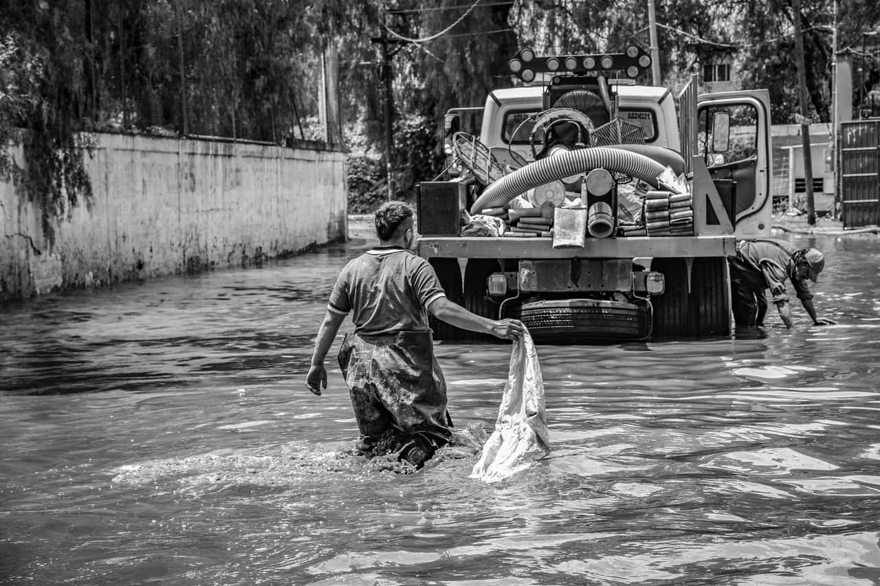 Sewage backup cleanup: Urban flood cleanup efforts in black and white