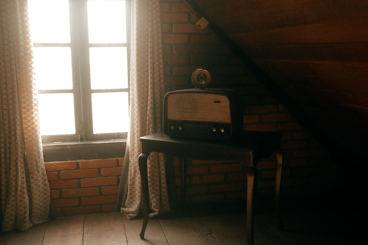 Signs of poor attic ventilation: Vintage radio in a rustic attic setting