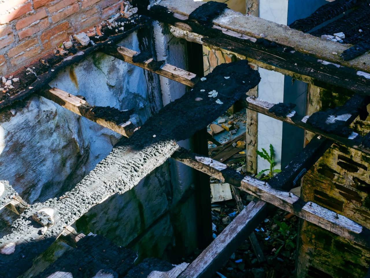 Sump pump installation cost: dark water and debris in a concrete pit
