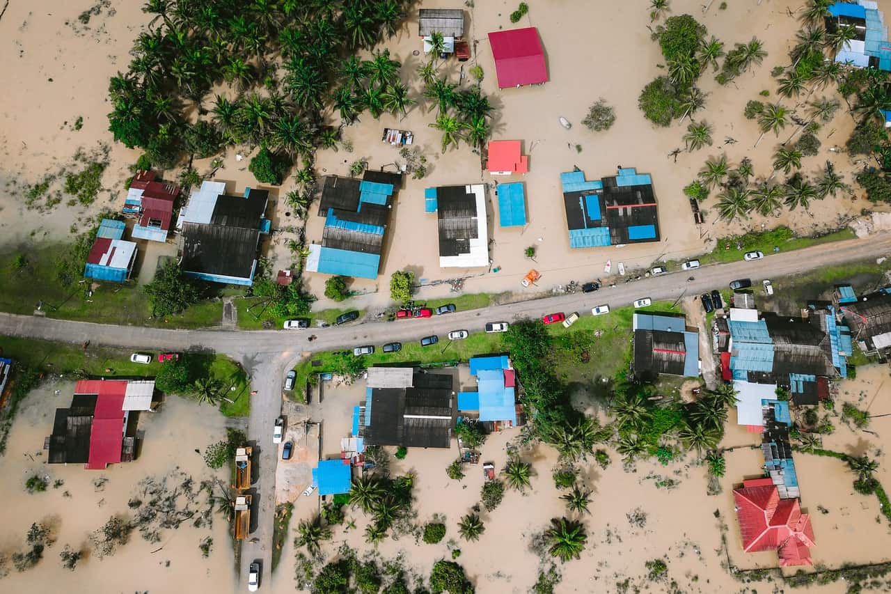 What is water damage restoration: Aerial view of houses surrounded by water