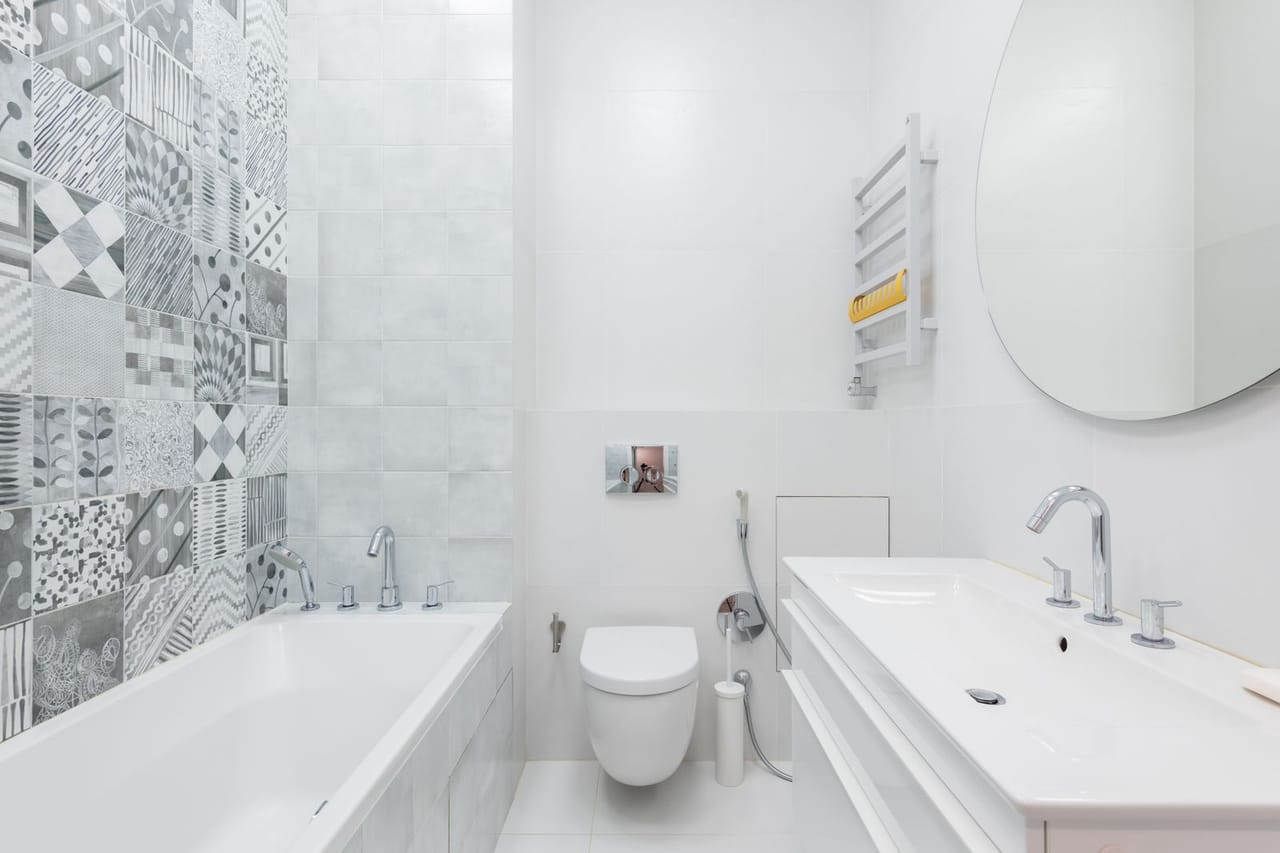 Why is my toilet gurgling: A white and gray bathroom and toilet with bathtub