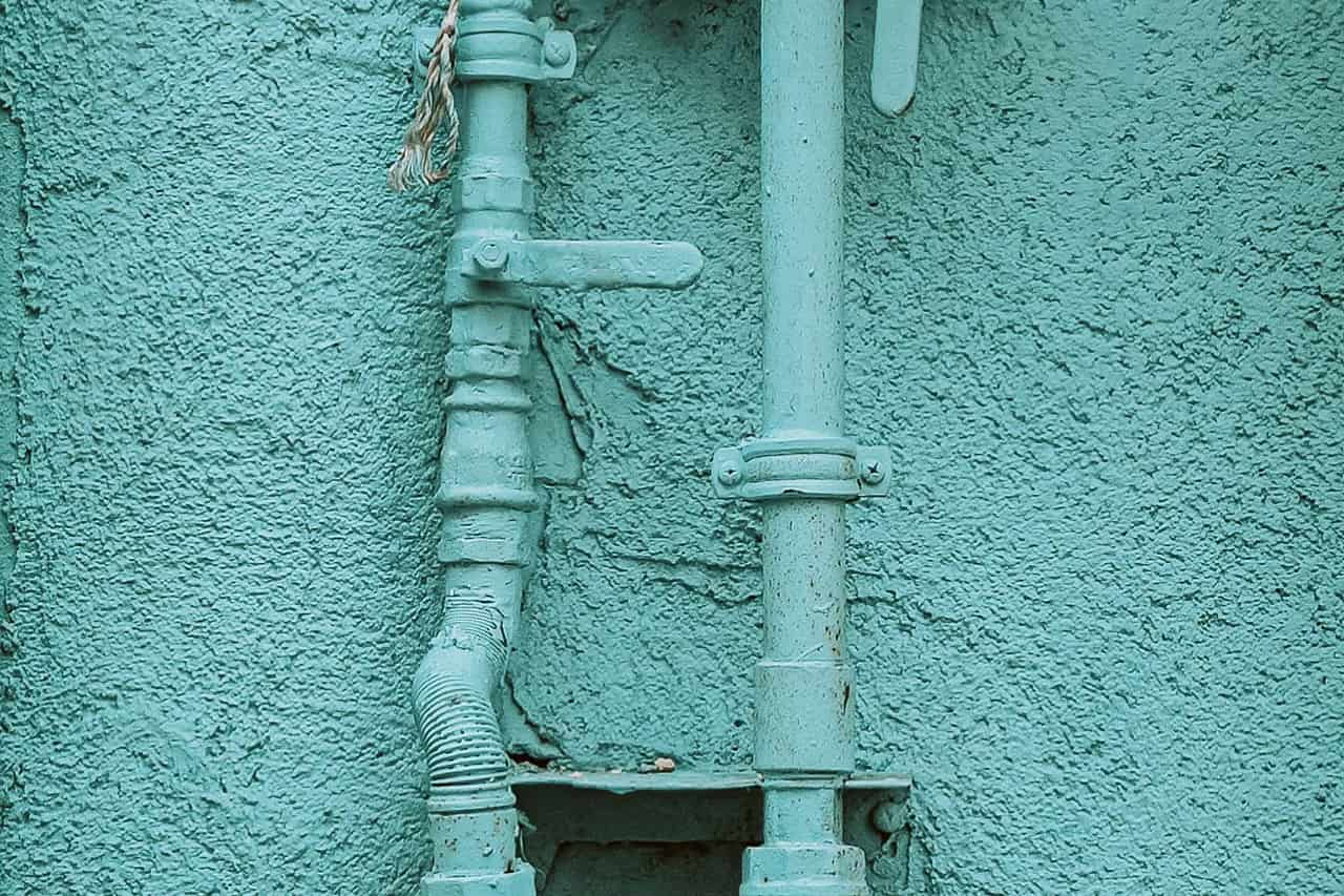 Plumber Appleton WI: Pipes and gas meter painted in the color of the house