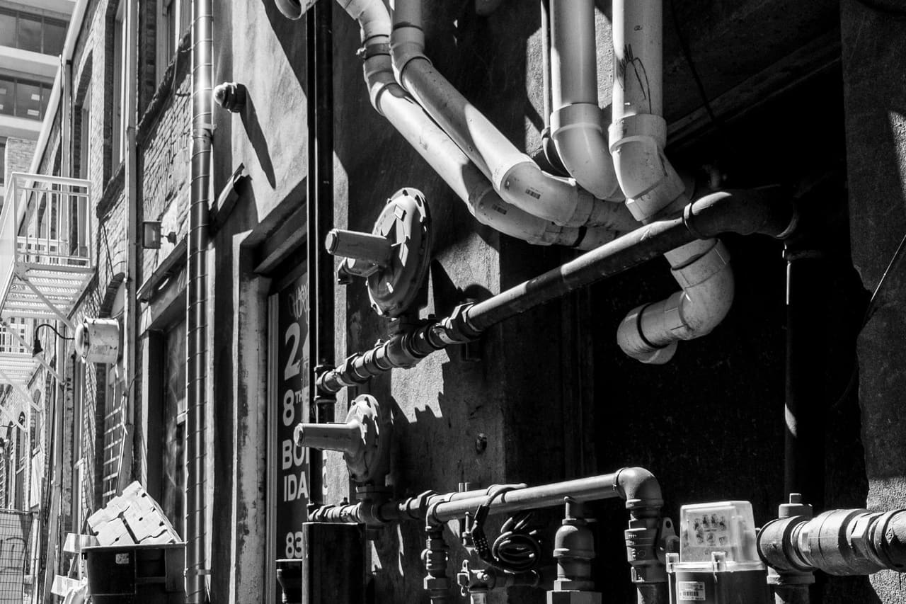 Plumber Burlington VT: Black and white photo of a street with pipes
