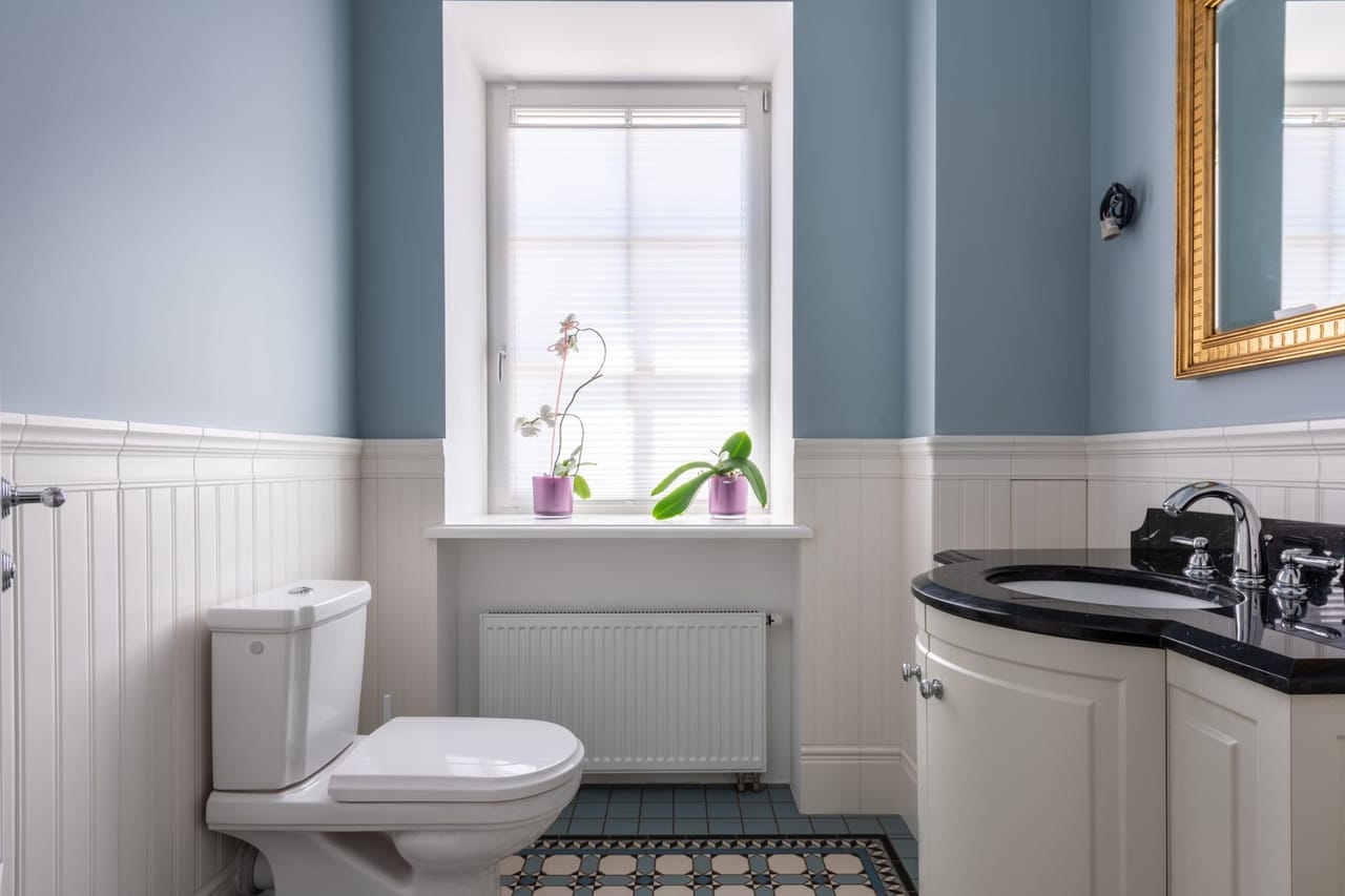 Plumber Conway AR: Interior of a comfort room with wood panels