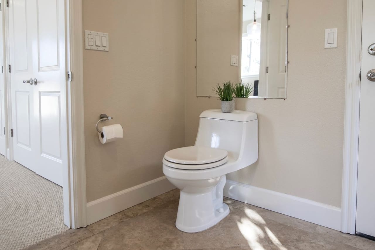 Plumber Escondido CA: A bathroom with a toilet and a door